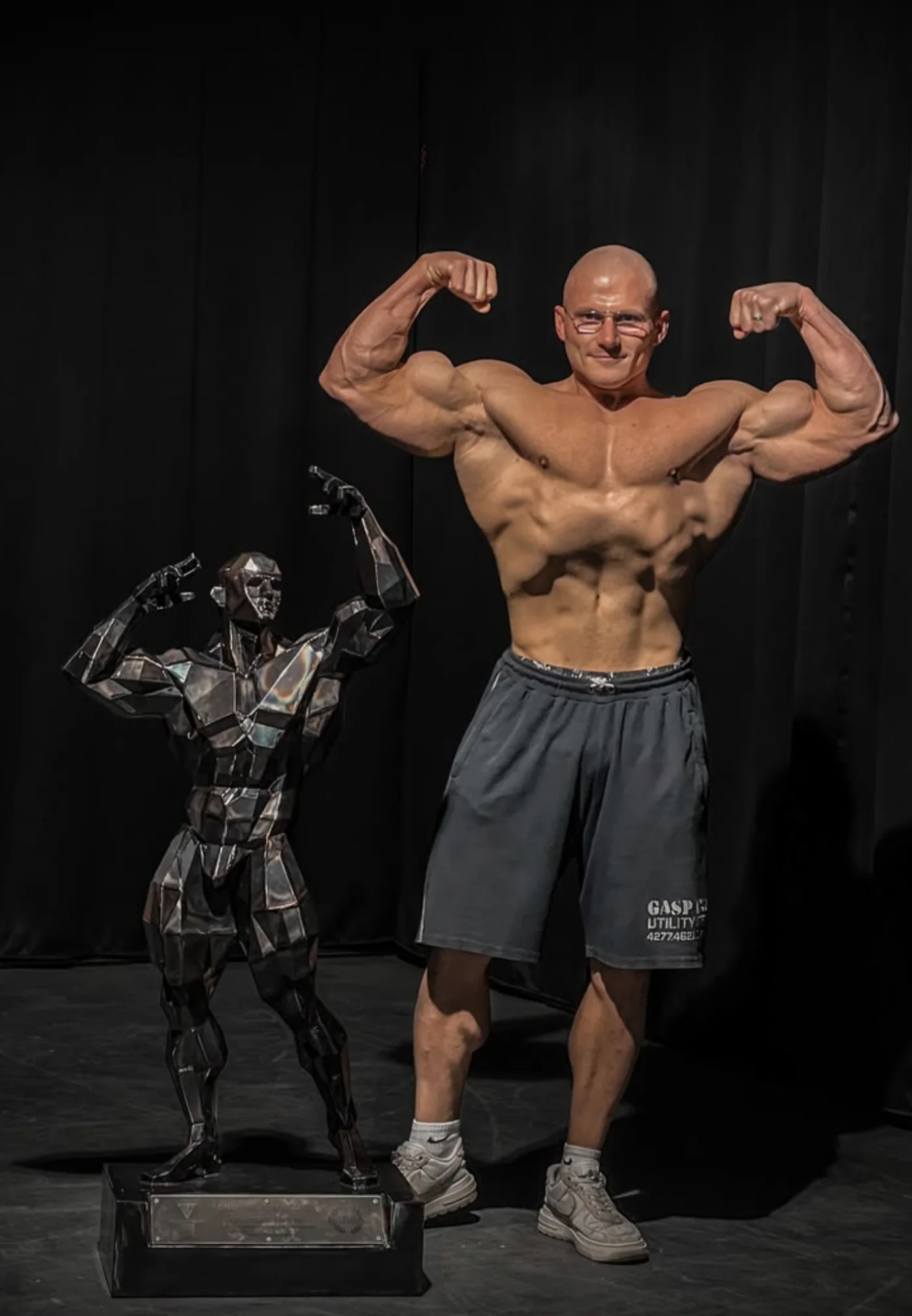 A Colossus Trophy beside the champion it honours